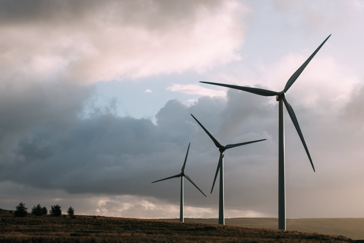 product-06 Wind turbines generating renewable energy under a dramatic cloudy sky.